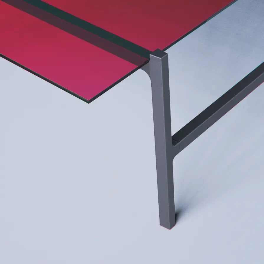 Corner detail of the table — magenta top meeting a slim dark metal leg