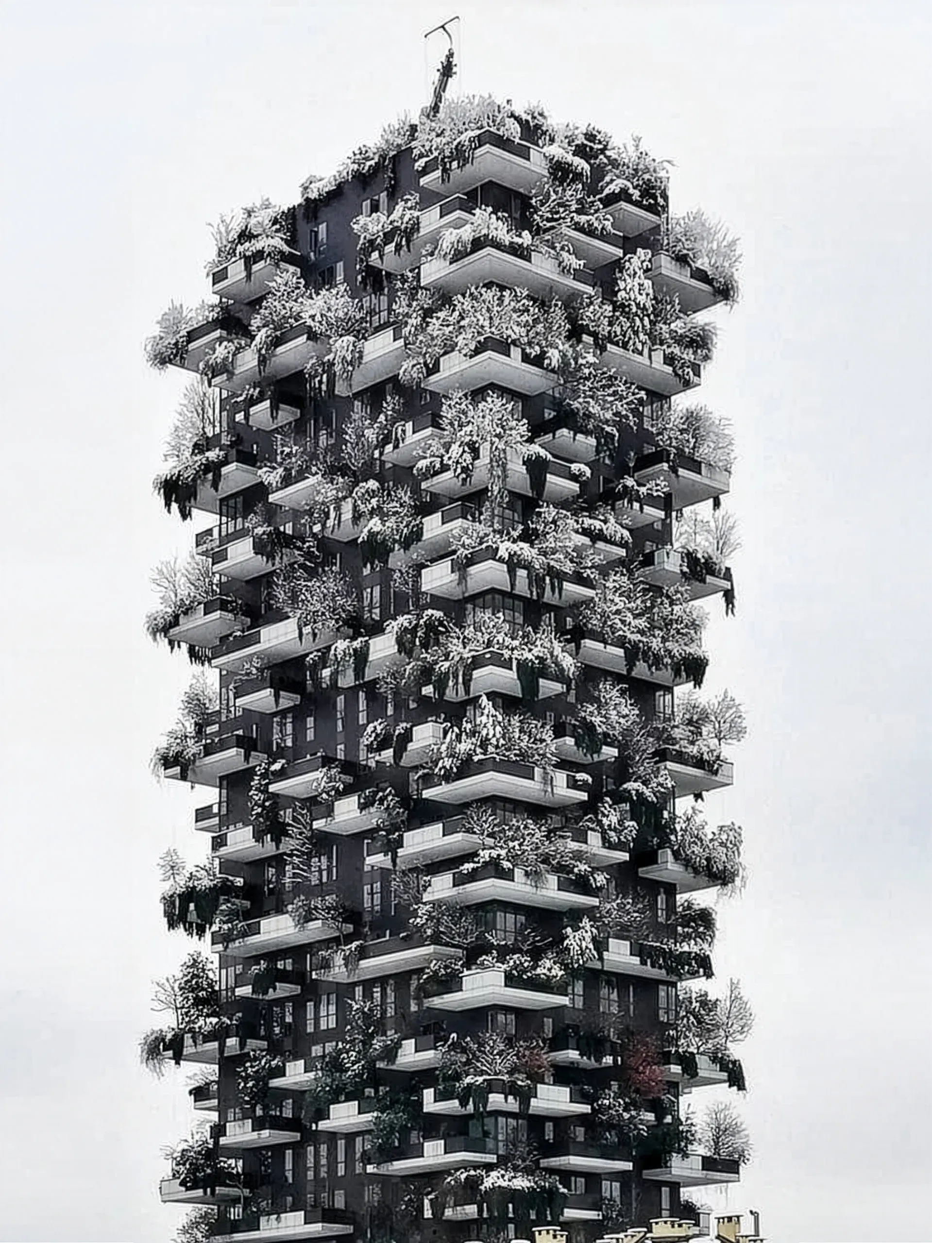 Bosco Verticale under snow — the tower's stacked balconies and the trees planted on them picked out white against a flat pale winter sky