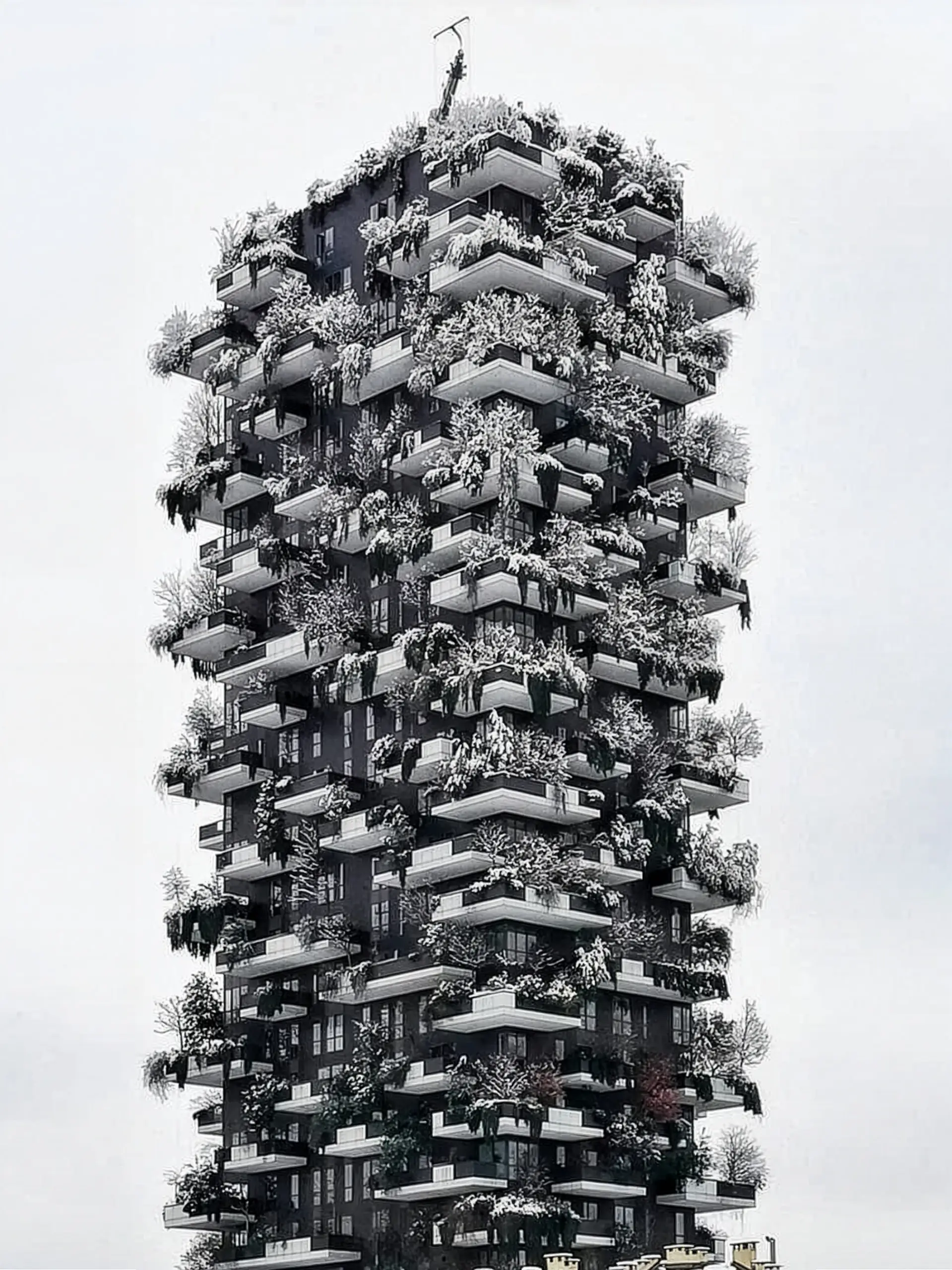 Bosco Verticale under snow — the tower's stacked balconies and the trees planted on them picked out white against a flat pale winter sky
