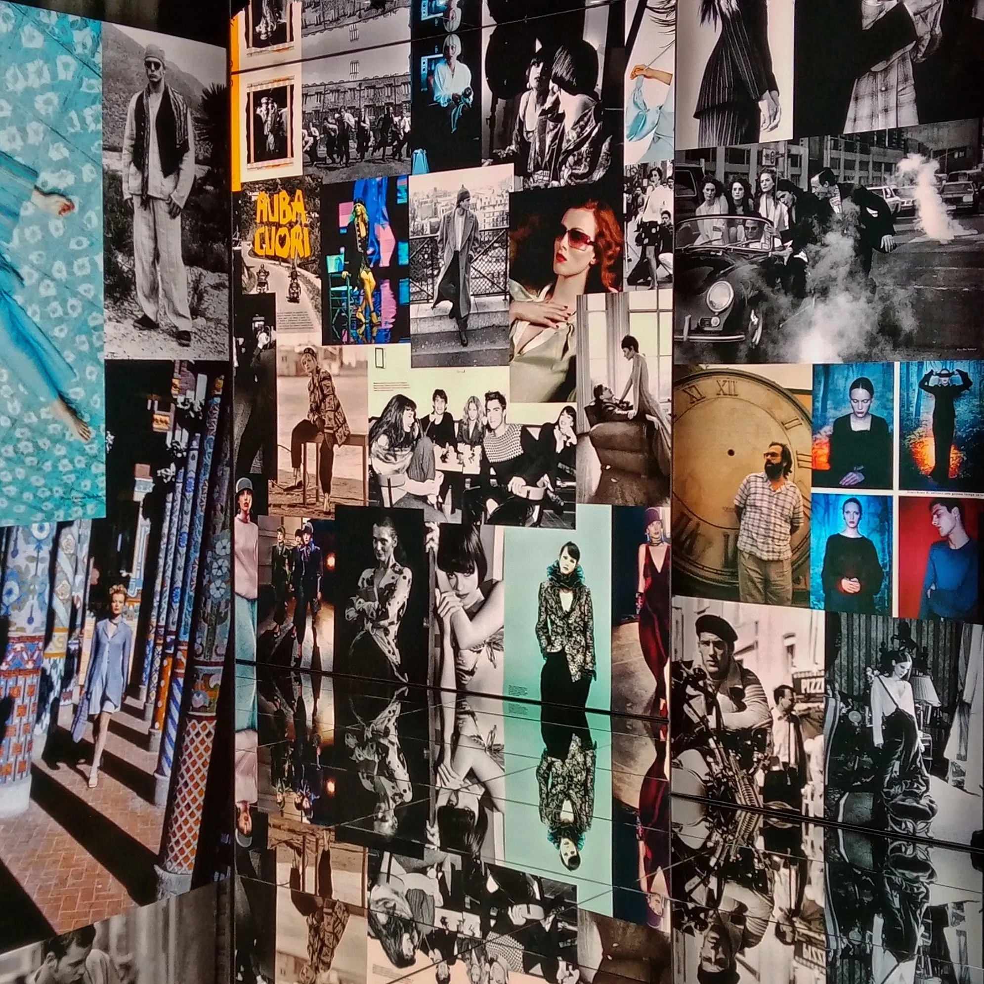 A wall papered edge to edge with magazine cuttings and photographs in colour and black and white