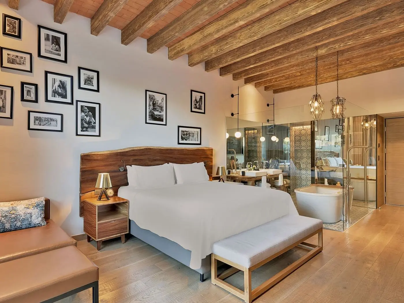 Guest room with a salon-hung wall of framed pictures above the bed
