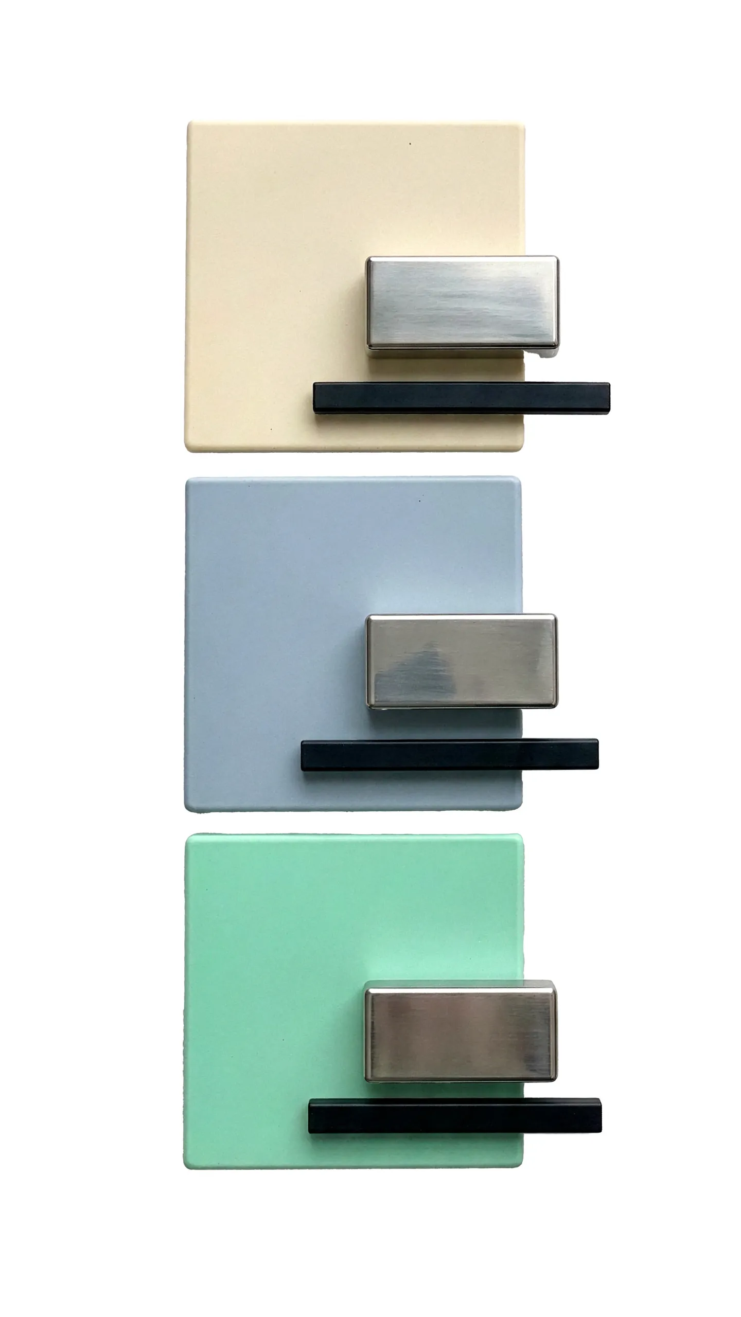 Physical finish samples stacked vertically — cream, pale blue and mint painted panels, each paired with a brushed-steel bar and a matt black extrusion