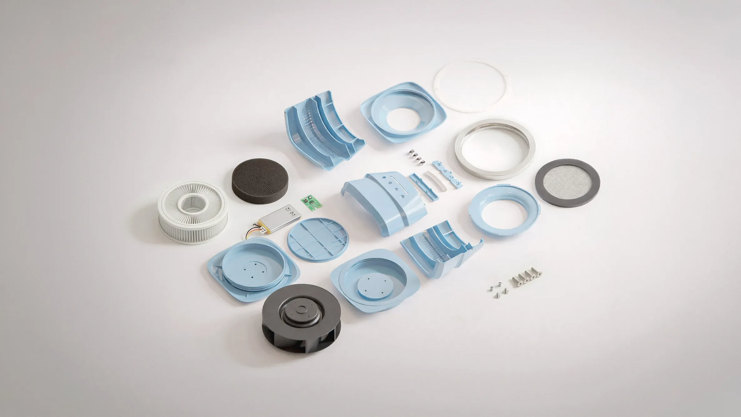 Exploded assembly — housing shells, impeller, filter, motor, PCB and fasteners laid out