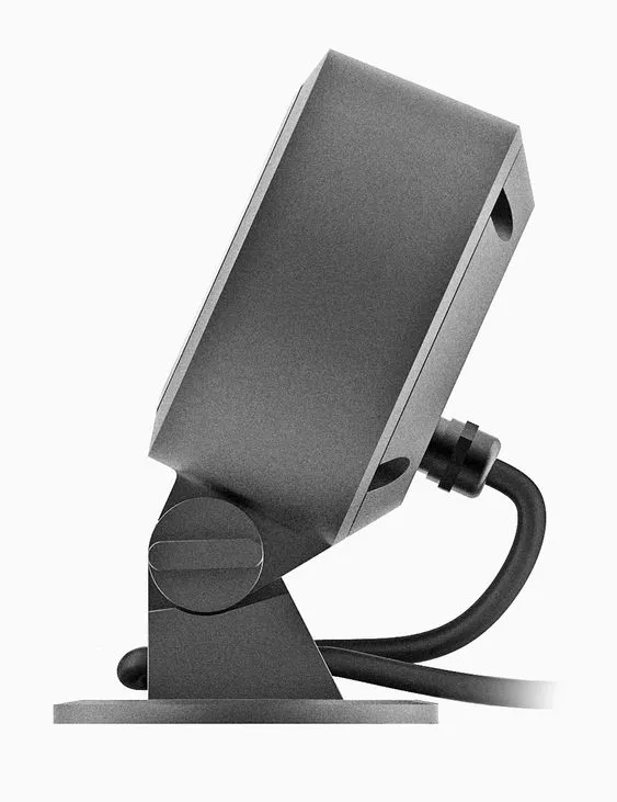 Render of a dark grey tilting fixture head on a round base — a single pivot joint and a thick moulded cable gland