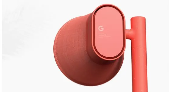 A coral-coloured camera on a matching post — matte fabric mesh body and a rounded rear plate