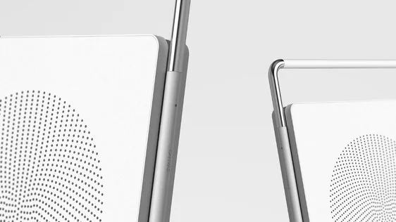 Macro of two white router panels standing on slim metal spines, each face carrying an arc of halftone dots