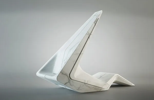 A folded marble lounge chair — one continuous white surface creased into a raked back and a seat
