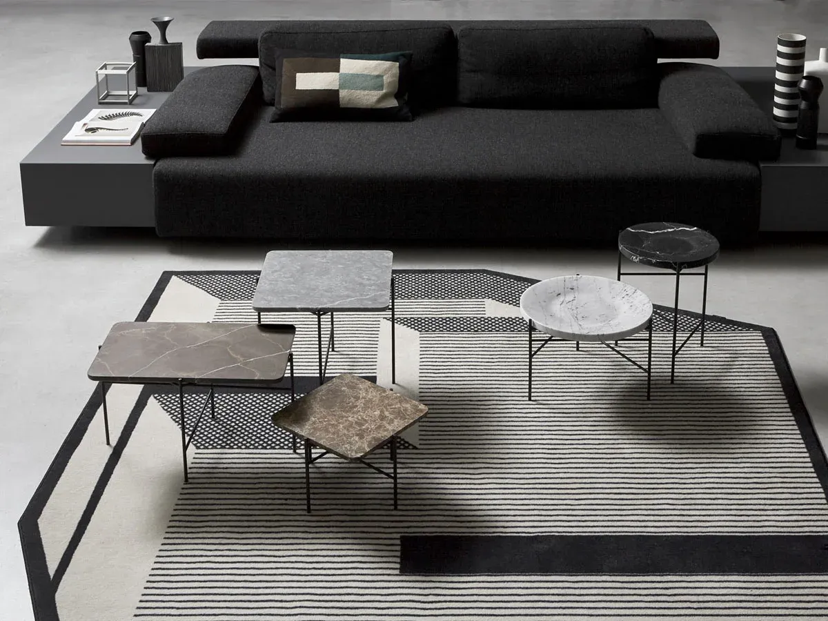 The same table family from a lower angle — the tops overlapping in silhouette, the frames reading as a single thicket of legs